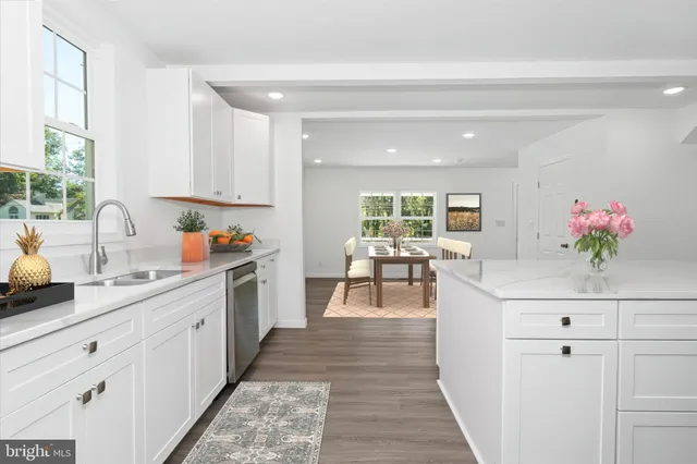 a kitchen with sink cabinets and living room view