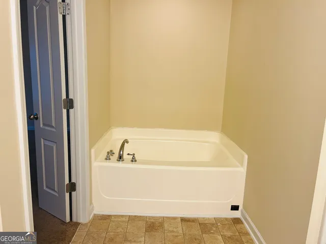 an empty room with closet area