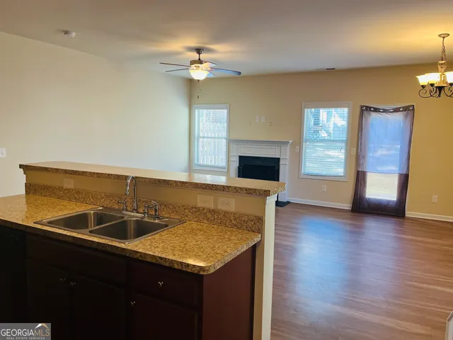a kitchen with granite countertop a refrigerator stove and microwave