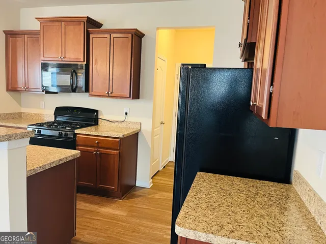 a view of a kitchen with a sink and a kitchen view