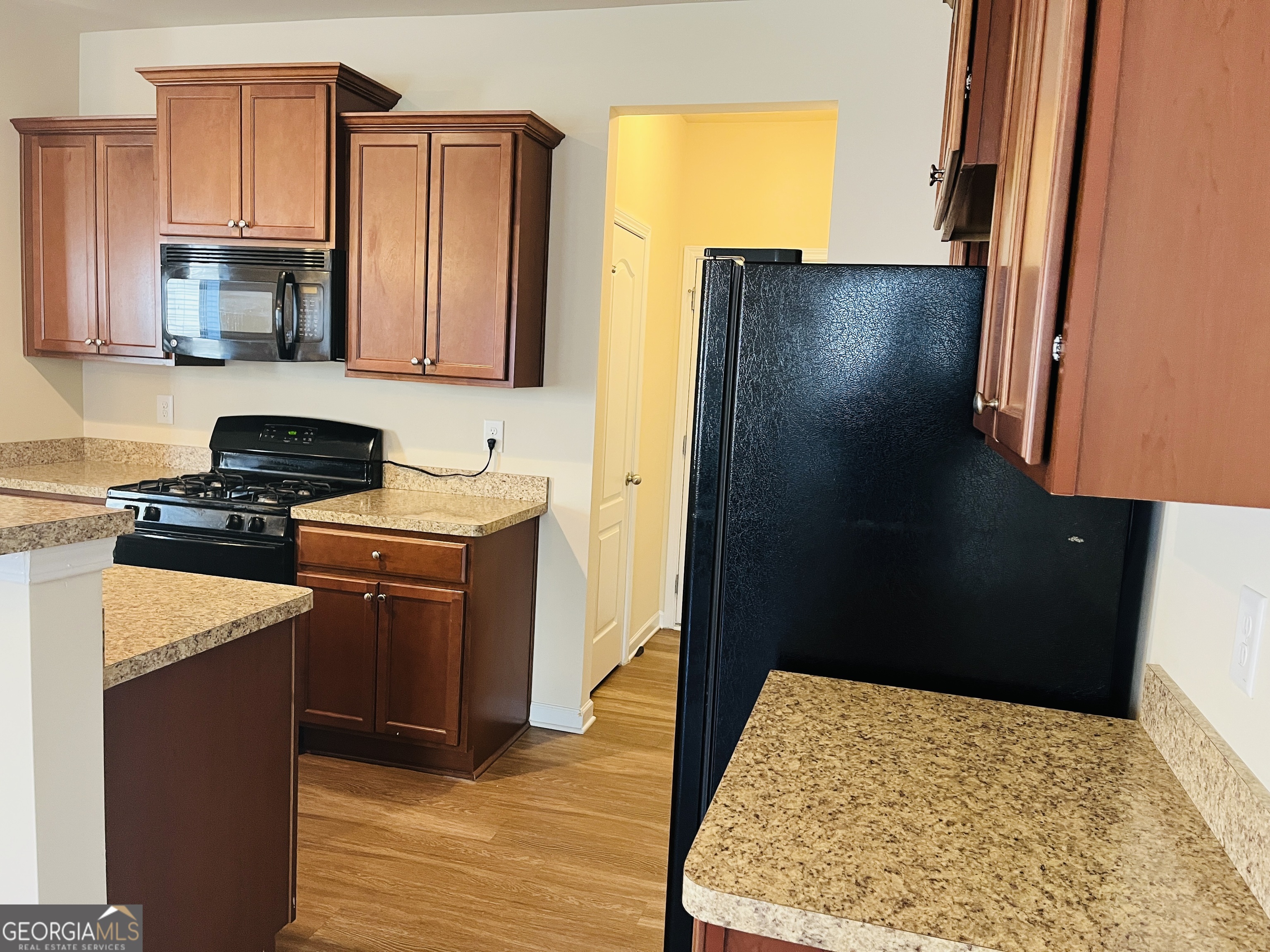 233 Bobbie Way Woodstock, GA 30189 - Photo 5 of 32 a kitchen with stainless steel appliances granite countertop a refrigerator stove and a sink