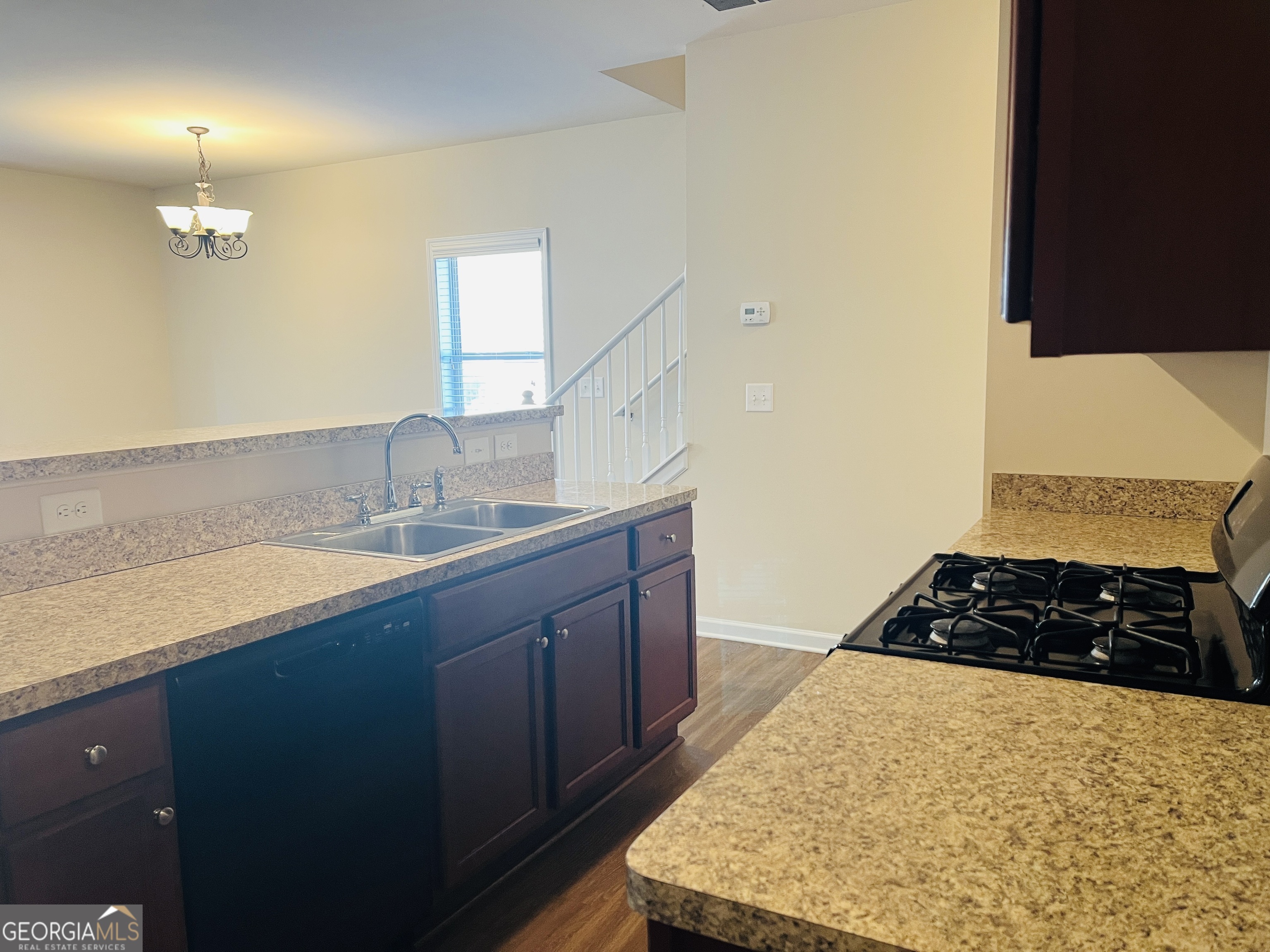 233 Bobbie Way Woodstock, GA 30189 - Photo 7 of 32 a kitchen with a sink and a stove