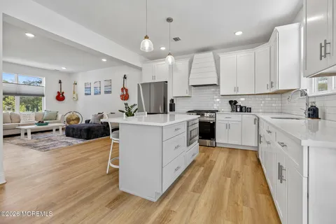 a kitchen with cabinets a sink and appliances
