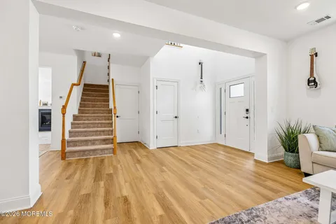 a view of a bedroom with wooden floor and stairs