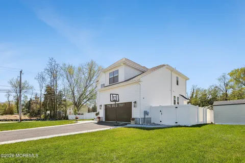 a view of a house with a yard and pathway