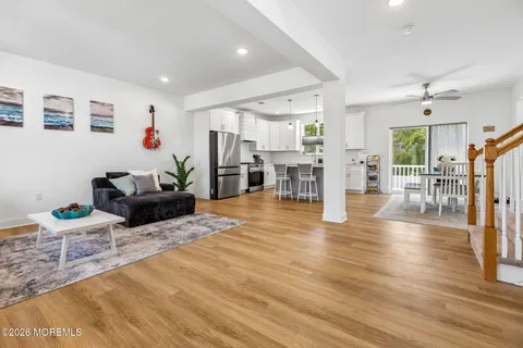 a living room with furniture and a wooden floor