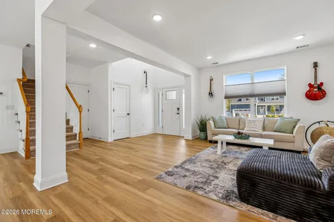 a living room with furniture and flowers