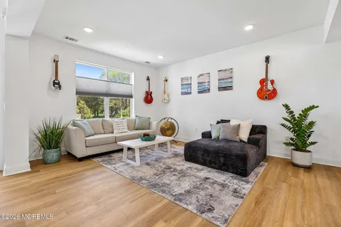 a living room with furniture potted plant and a table