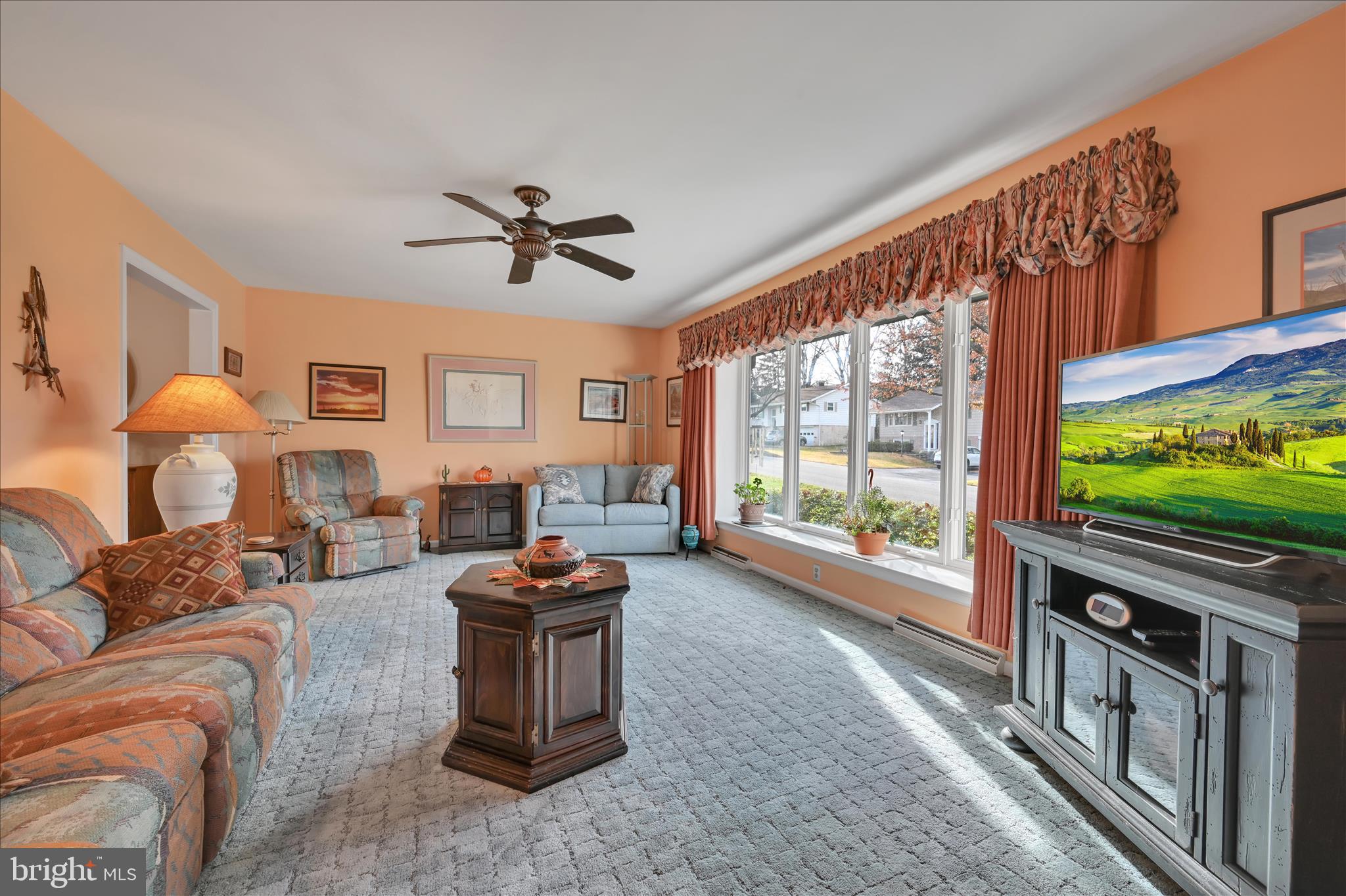 2295 Albern Boulevard Lancaster, PA 17601 - Photo 7 of 39 a living room with furniture a flat screen tv and a floor to ceiling window
