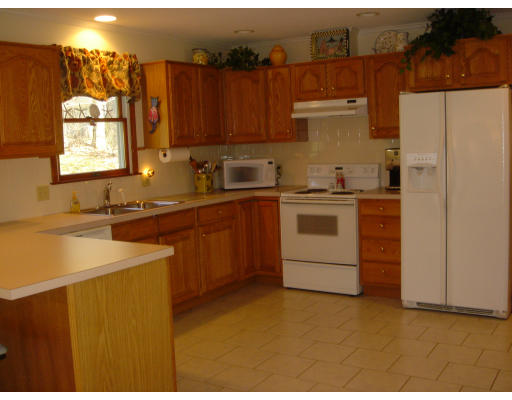 24 Merrill Road Wilbraham, MA 01095 - Photo 3 of 7 a kitchen with a stove sink and cabinets