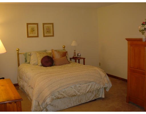 24 Merrill Road Wilbraham, MA 01095 - Photo 6 of 7 a bedroom with a bed and a cabinets