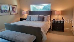 650 Golden Gate Point, Unit 301 Sarasota, FL 34236 - Photo 18 of 31 a bed sitting in a bedroom next to a window