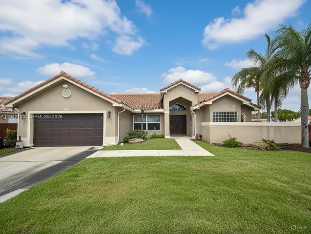 a front view of a house with a yard and garage