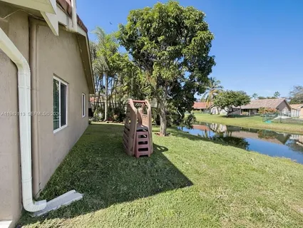 a view of a garden with plants and a lake view