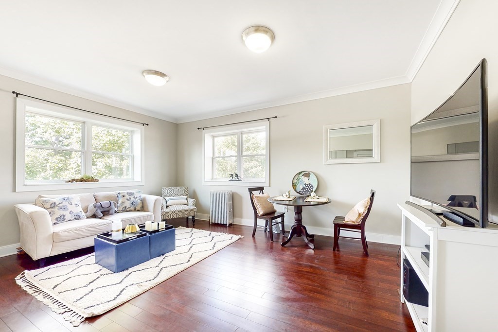 1834 Beacon Street, Unit 16 Brookline, MA 02445 - Photo 1 of 21 a living room with furniture wooden floor and floor to ceiling windows
