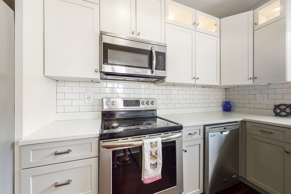 1834 Beacon Street, Unit 16 Brookline, MA 02445 - Photo 16 of 21 a kitchen with appliances a sink and cabinets