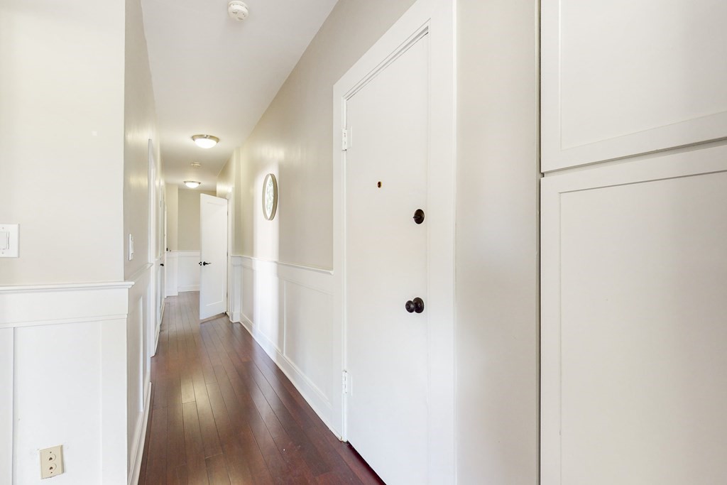 1834 Beacon Street, Unit 16 Brookline, MA 02445 - Photo 17 of 21 a view of a hallway with wooden floor