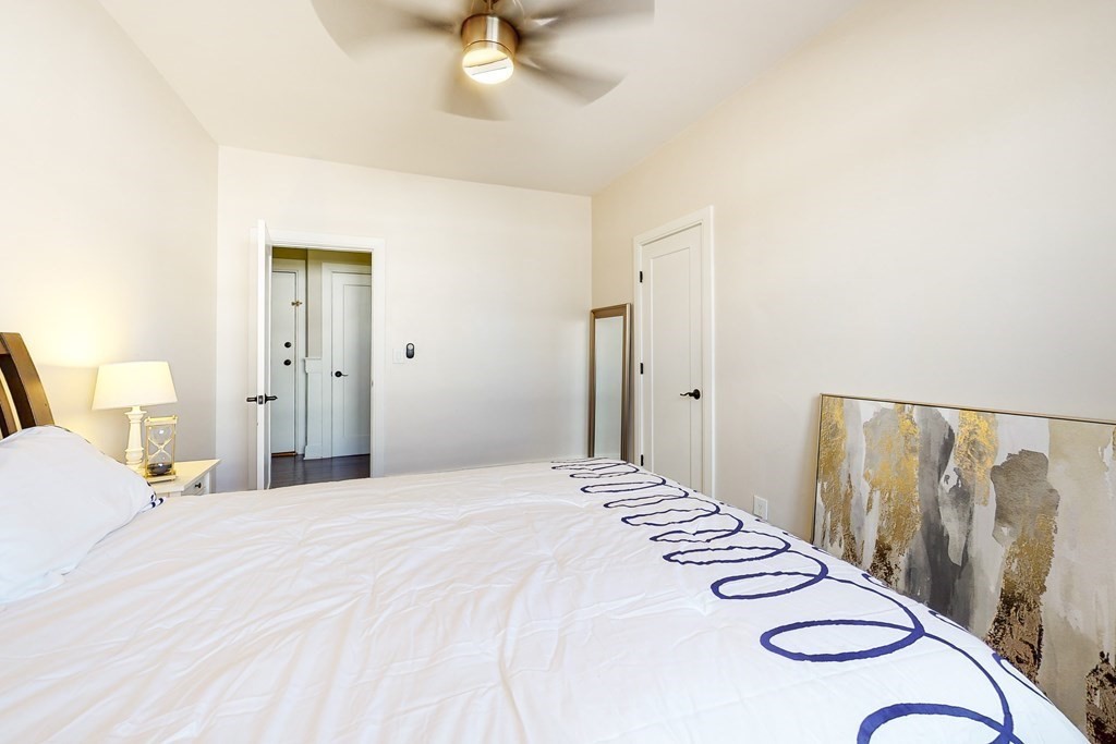 1834 Beacon Street, Unit 16 Brookline, MA 02445 - Photo 5 of 21 a bedroom with a bed and a chandelier
