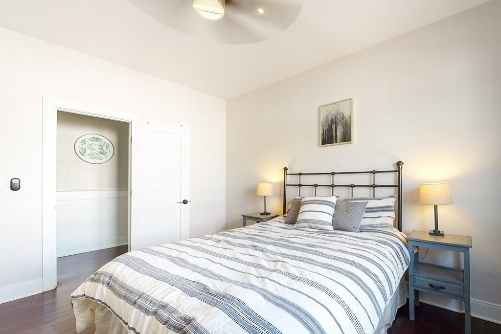 1834 Beacon Street, Unit 16 Brookline, MA 02445 - Photo 8 of 21 a bedroom with a bed and a lamp