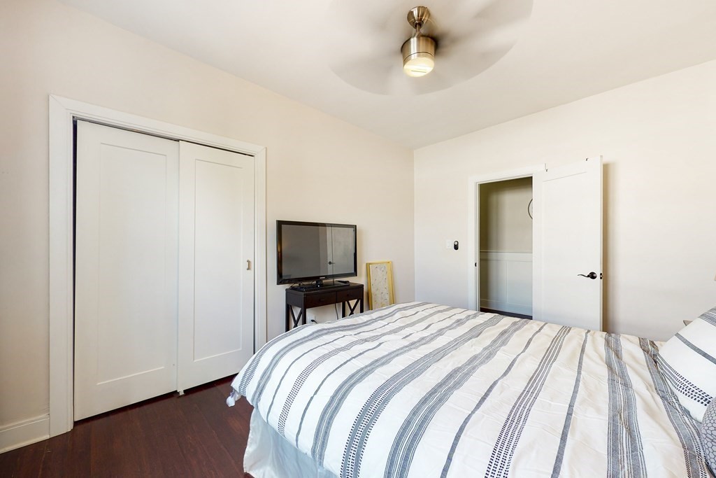 1834 Beacon Street, Unit 16 Brookline, MA 02445 - Photo 10 of 21 a bedroom with a bed and a flat screen tv