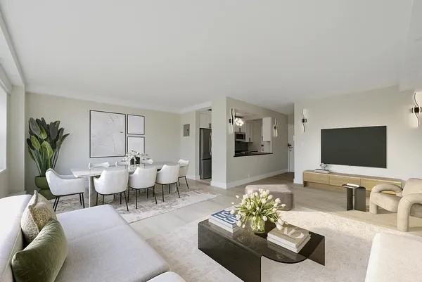 a living room with furniture potted plant and a flat screen tv