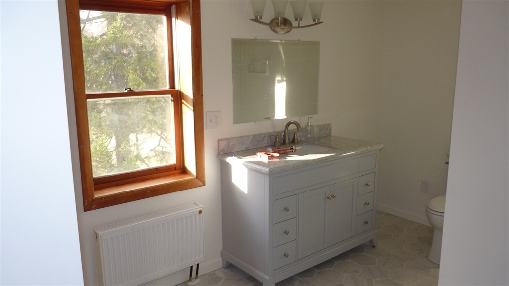 52 Valley Road Southampton, MA 01073 - Photo 17 of 18 a bathroom with a sink vanity and a mirror