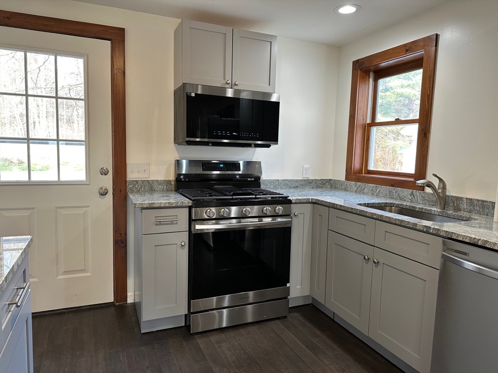 52 Valley Road Southampton, MA 01073 - Photo 10 of 18 a kitchen with stainless steel appliances a stove a microwave and sink