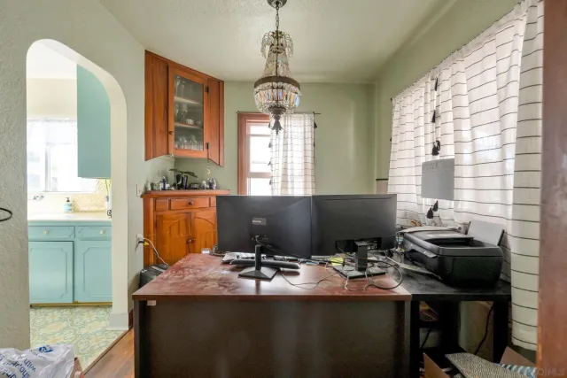 a view of a workspace with furniture and a window
