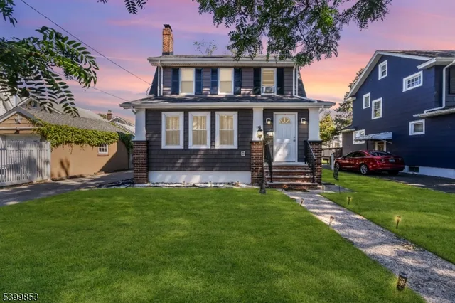 a front view of a house with a garden