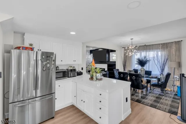 a kitchen with refrigerator and cabinets