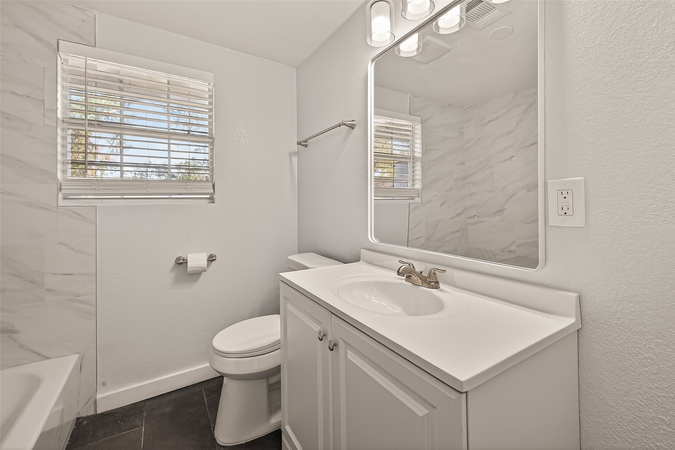 754 Prosper Street Houston, TX 77088 - Photo 16 of 28 a bathroom with a sink a toilet and a mirror