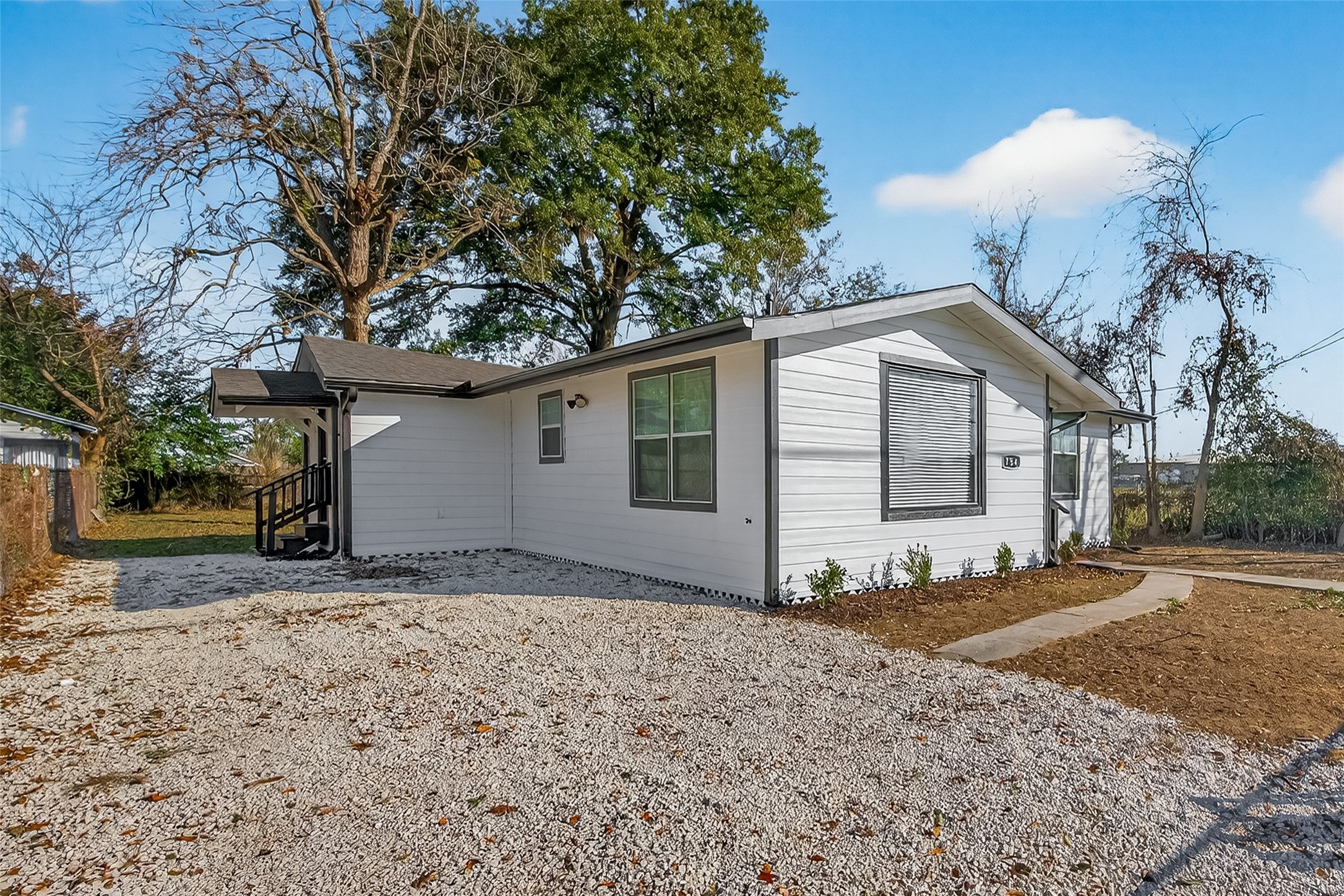 754 Prosper Street Houston, TX 77088 - Photo 2 of 28 a view of a house with a yard and large tree