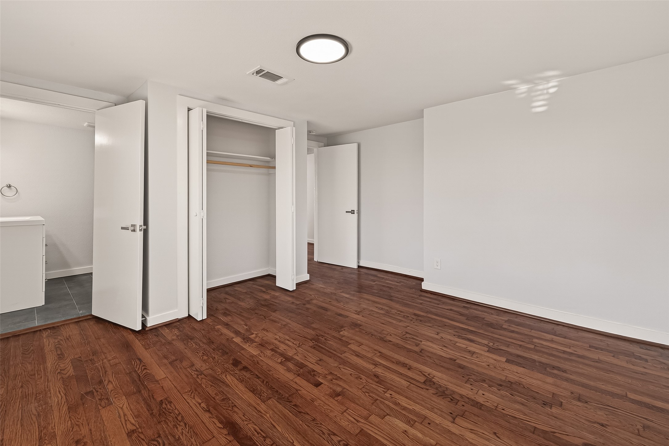 754 Prosper Street Houston, TX 77088 - Photo 22 of 28 an empty room with wooden floor and windows