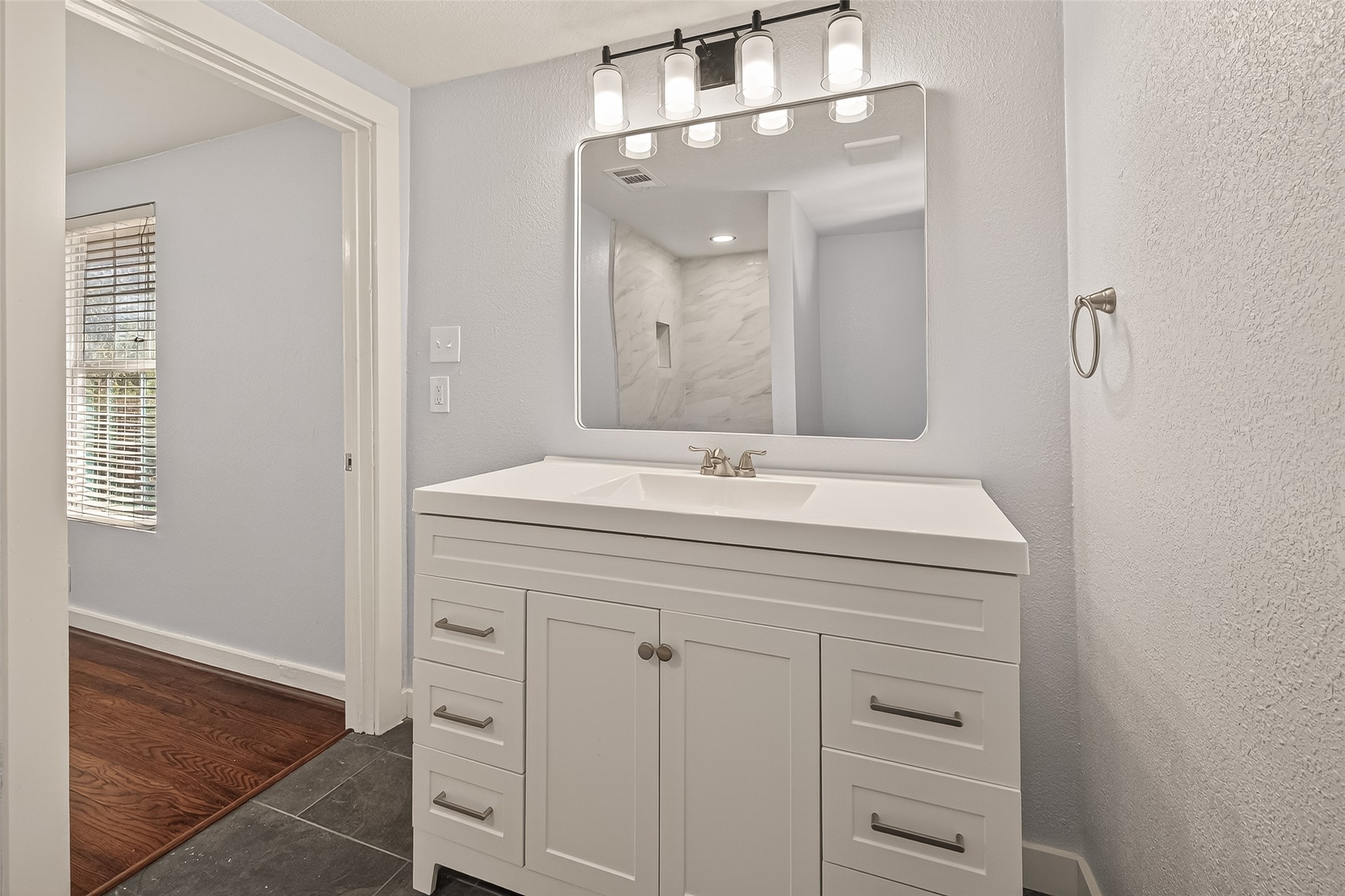 754 Prosper Street Houston, TX 77088 - Photo 25 of 28 a bathroom with a sink vanity and a mirror