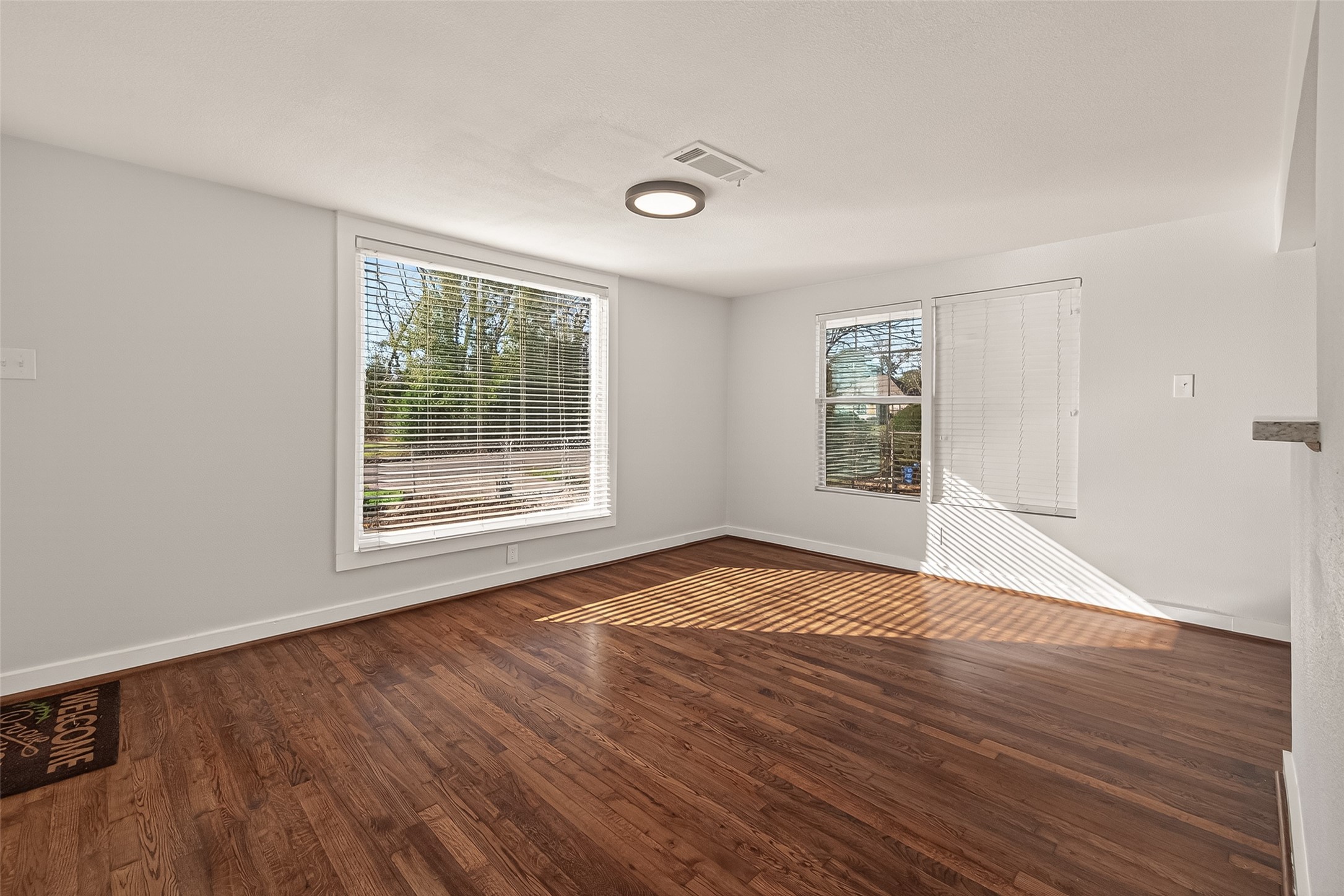 754 Prosper Street Houston, TX 77088 - Photo 4 of 28 a view of an empty room with wooden floor and a window