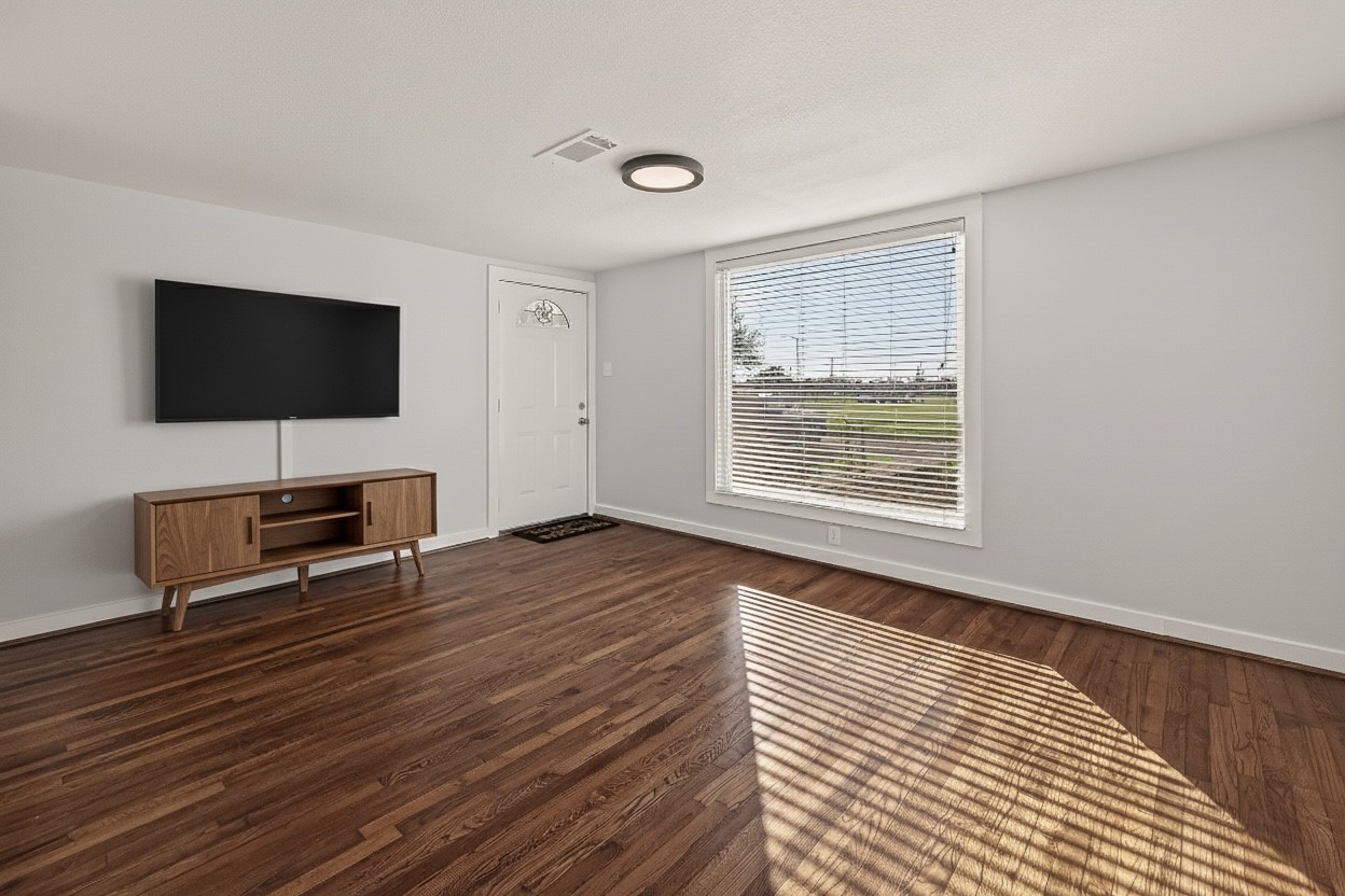 754 Prosper Street Houston, TX 77088 - Photo 7 of 28 a living room with furniture and a flat screen tv