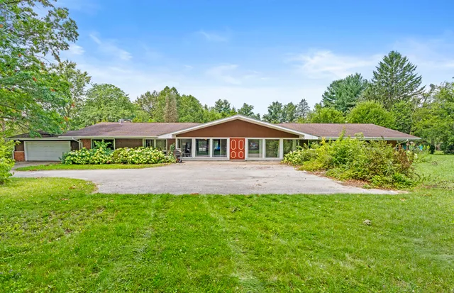 a front view of house with yard and green space