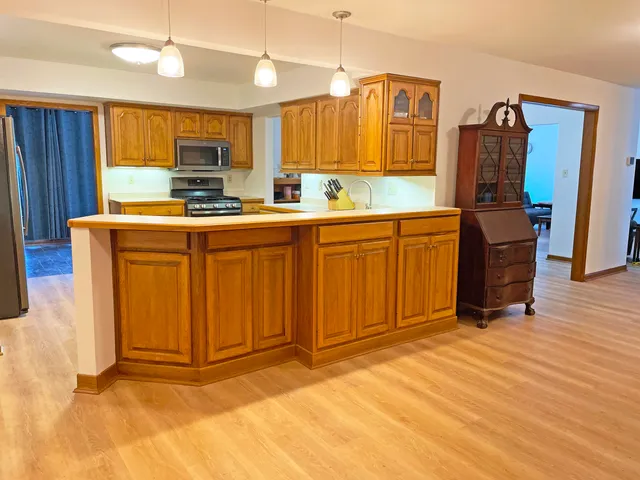 a kitchen with stainless steel appliances granite countertop a sink stove and refrigerator