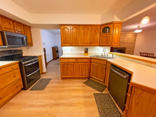 a kitchen with stainless steel appliances granite countertop a stove and a refrigerator