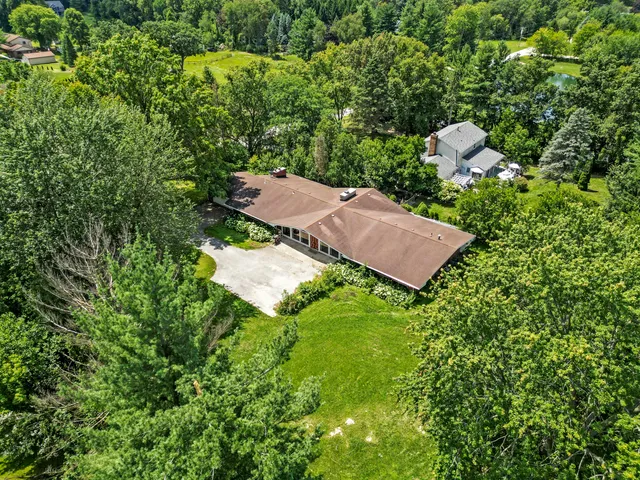 an aerial view of a house with yard and outdoor seating