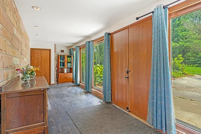 a view of hallway with furniture and a window