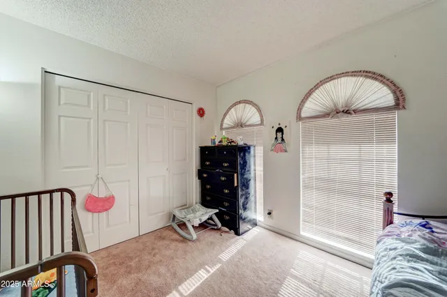 a bed room with a bed and a window