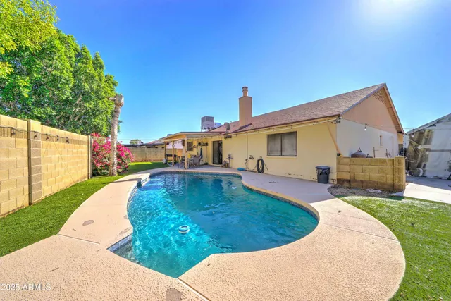 a view of a house with backyard porch and sitting area