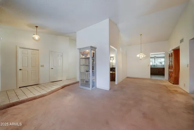 a view of empty room with closet and windows