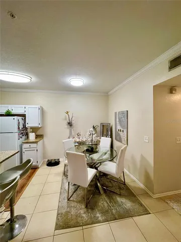 a living room with furniture a rug and white walls