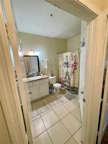 a bedroom with a bed dresser and a large mirror