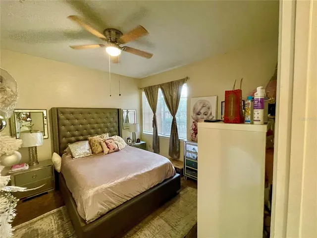 a bedroom with furniture and a flat screen tv