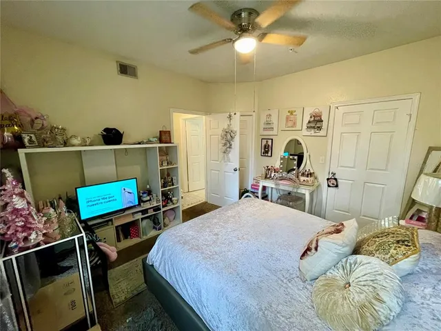 a bedroom with a bed a mirror and dresser