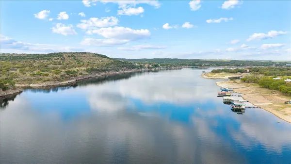 an aerial view of a houses with a lake view