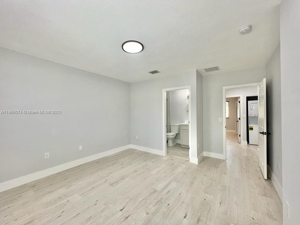 14116 Southwest 260th Street, Unit 106 Homestead, FL 33032 - Photo 12 of 24 wooden floor in an empty room